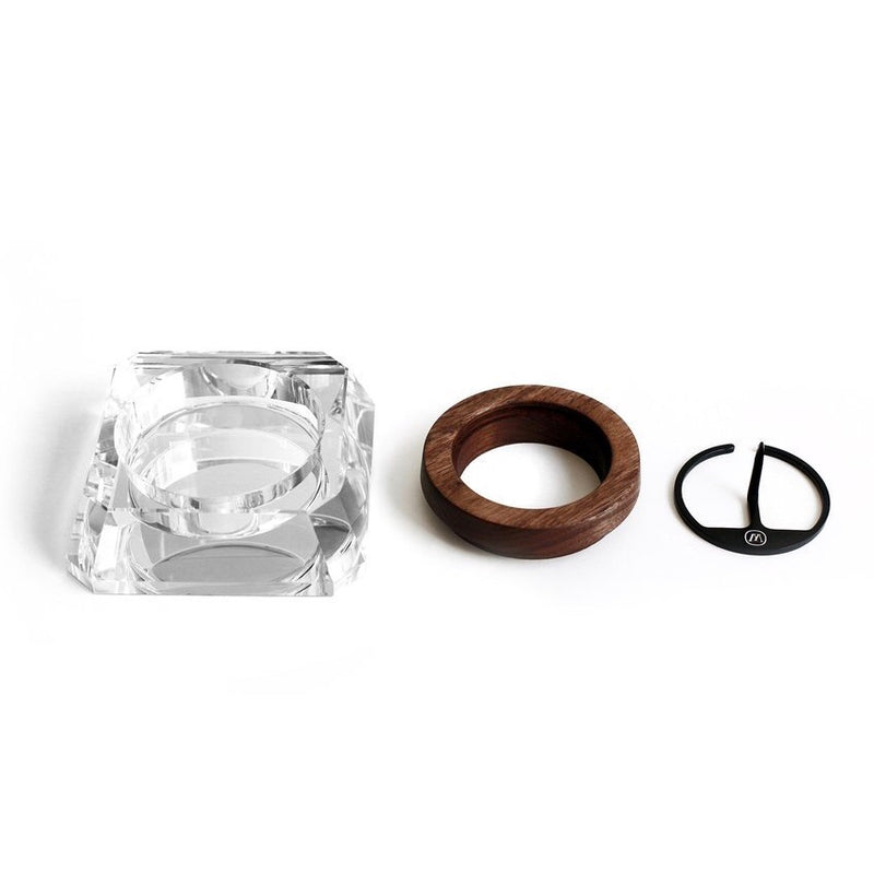a couple of rings sitting next to a piece of glass