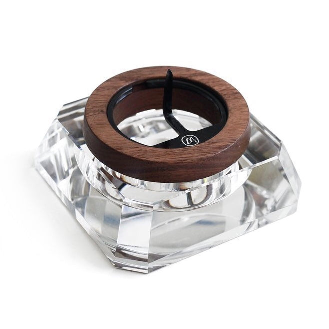 a wooden ring sitting on top of a glass block
