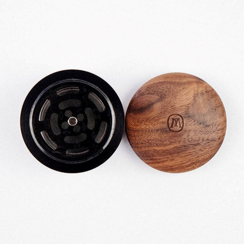 a wooden grinder sitting on top of a white surface