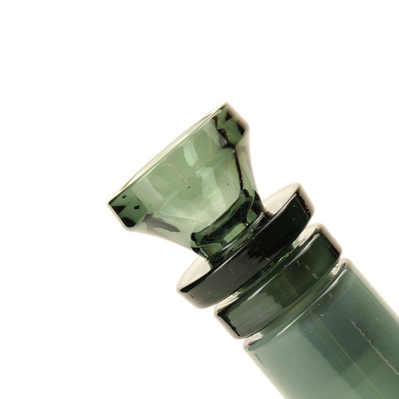 a close up of a green glass object on a white background