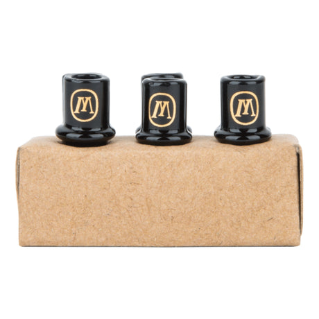a couple of black knobs sitting on top of a cardboard box