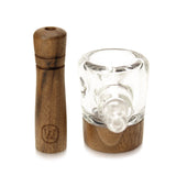 a glass and wooden pepper mill on a white background